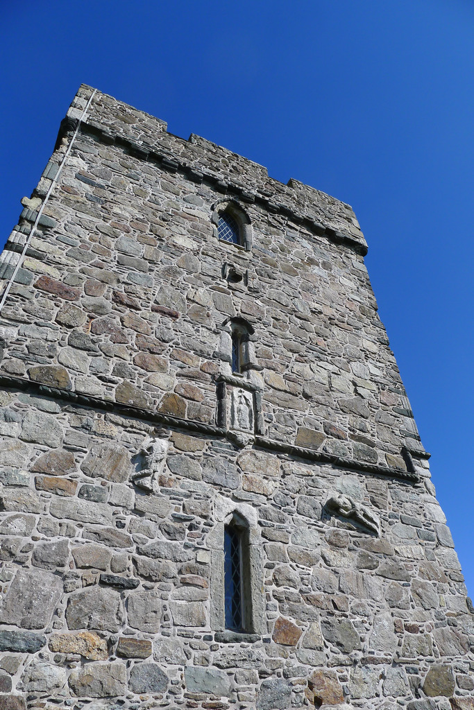 StClements_R0391.JPG - This shows some of the carved stones that were incorporated into the 16th Century church from an ealier structure. One of them shows a man in a kilt type garment. 